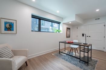 a living room with a desk and a chair and a window at Matilda 235 Townhomes, Des Moines, 50309